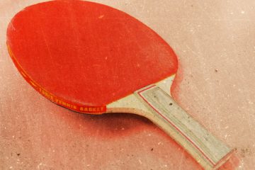 A ping pong paddle resting on a surface